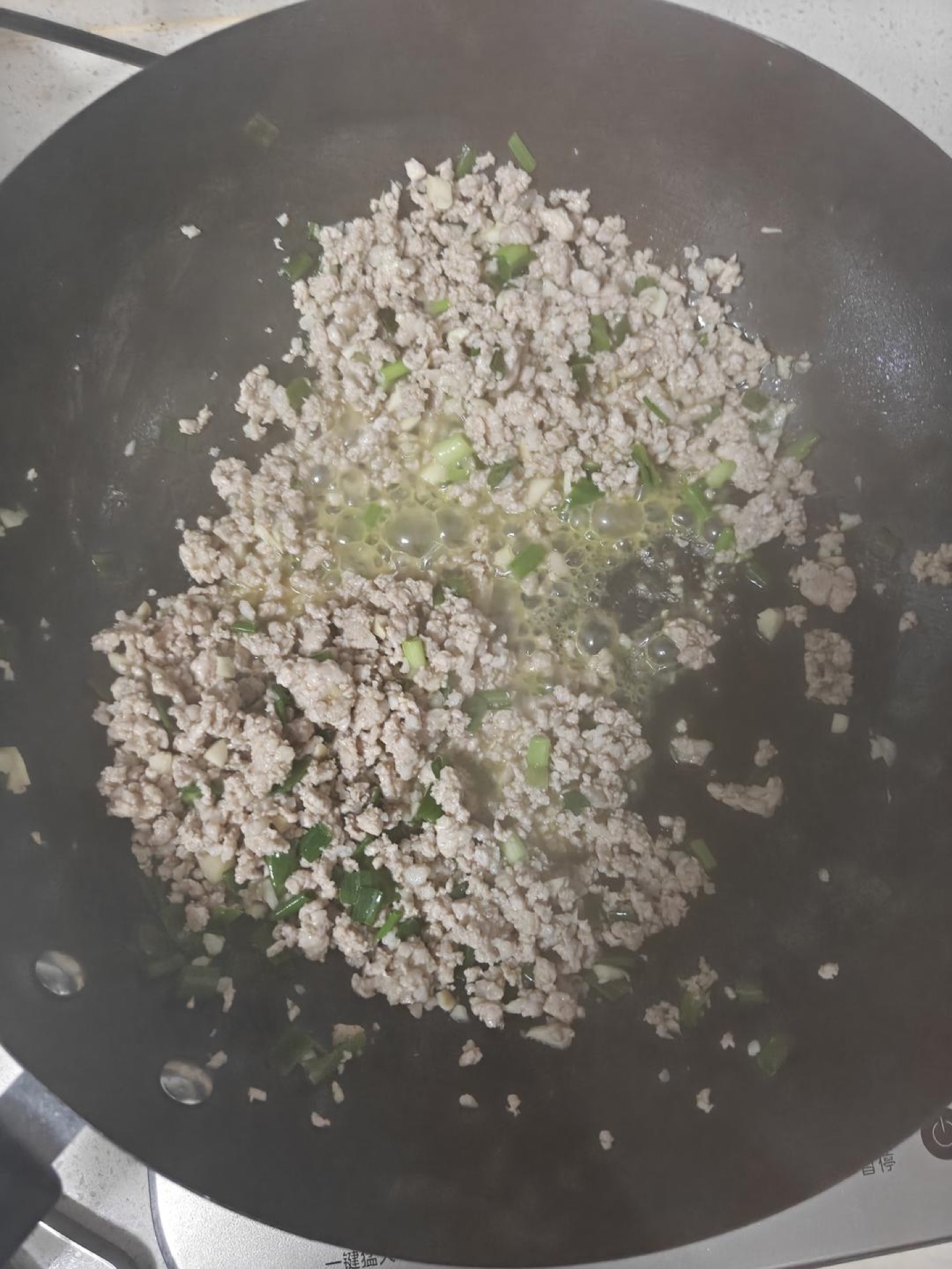 Add the minced garlic and scallion whites and stir-fry for about 30 seconds, until they smell sweet and fragrant.
