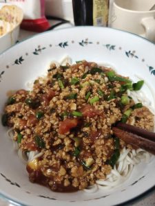 Spoon the warm meat sauce over the drained noodles and toss gently so every strand is coated, then serve immediately.