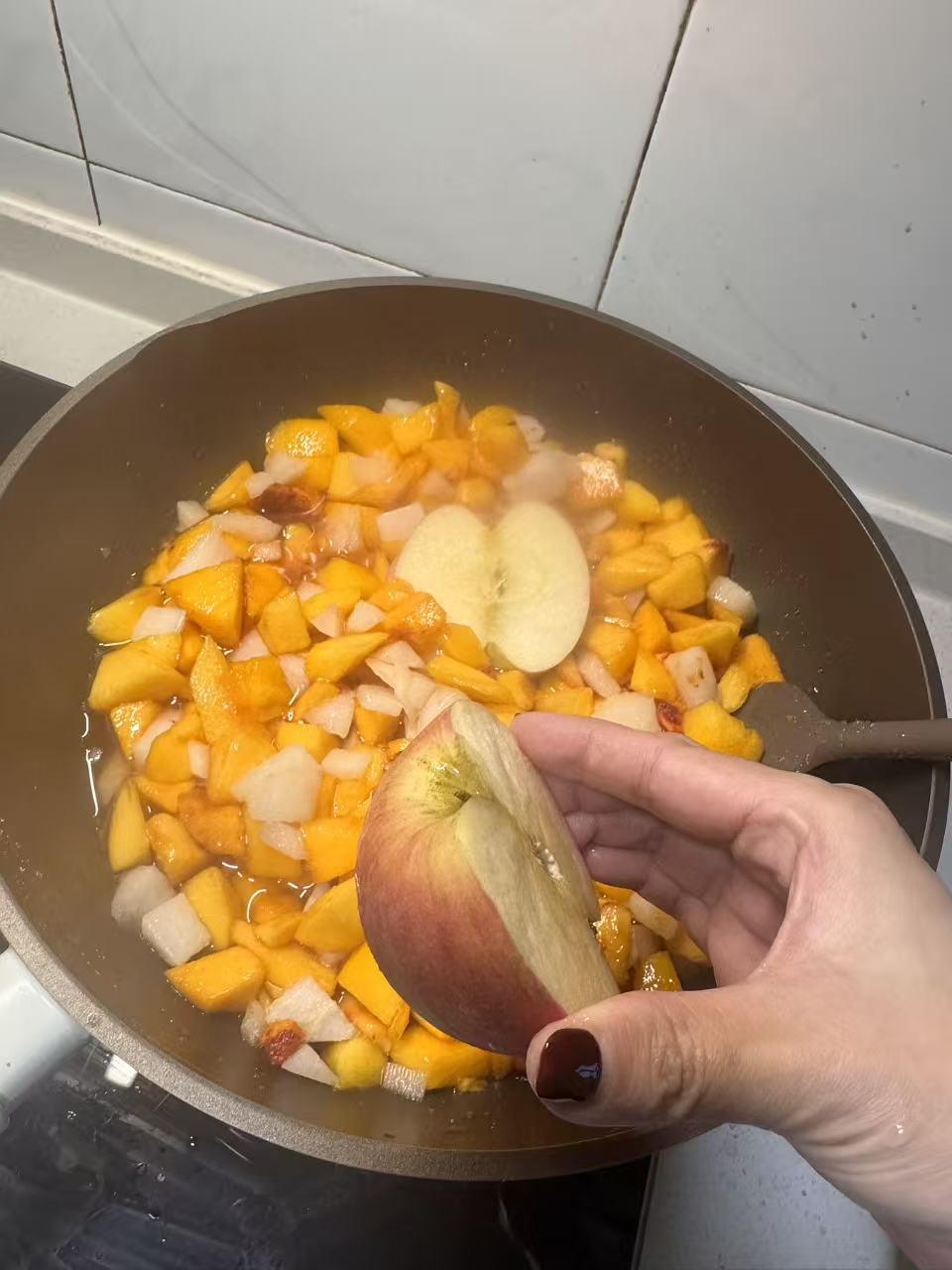 Halved apples with skin and core added to the jam pot for pectin