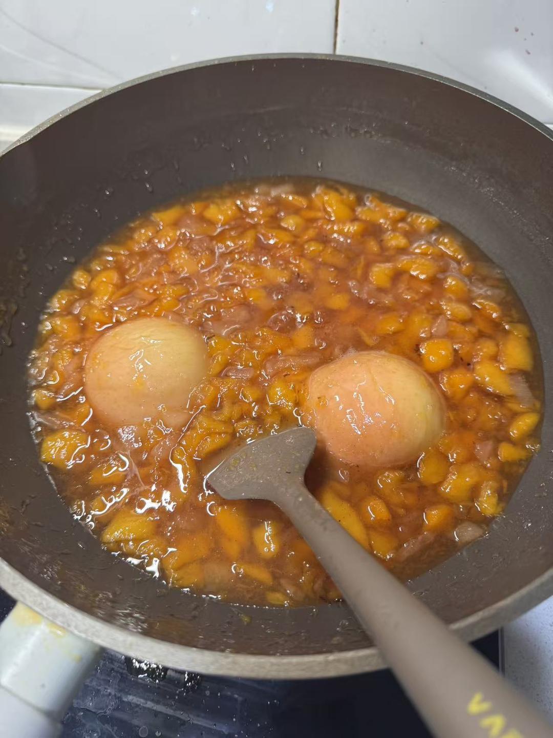 Uncovered jam boiling down to a thick glossy consistency