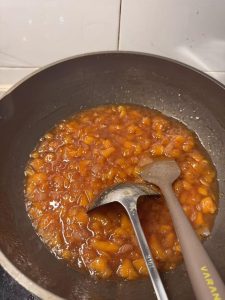 Thick amber vanilla peach and pear jam poured hot into jars