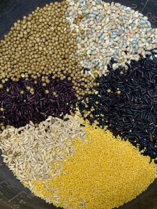Rinse the hulless barley, oat, black rice, purple rice, millet, and buckwheat, then cook them with the water in a rice cooker until tender and chewy — mix your own blend freely, or