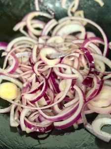 Add a little more olive oil to the pan and stir-fry the sliced onion until fragrant and soft.