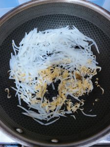 Scatter in the rinsed dried shrimp and stir-fry for another minute so they toast and perfume the radish.