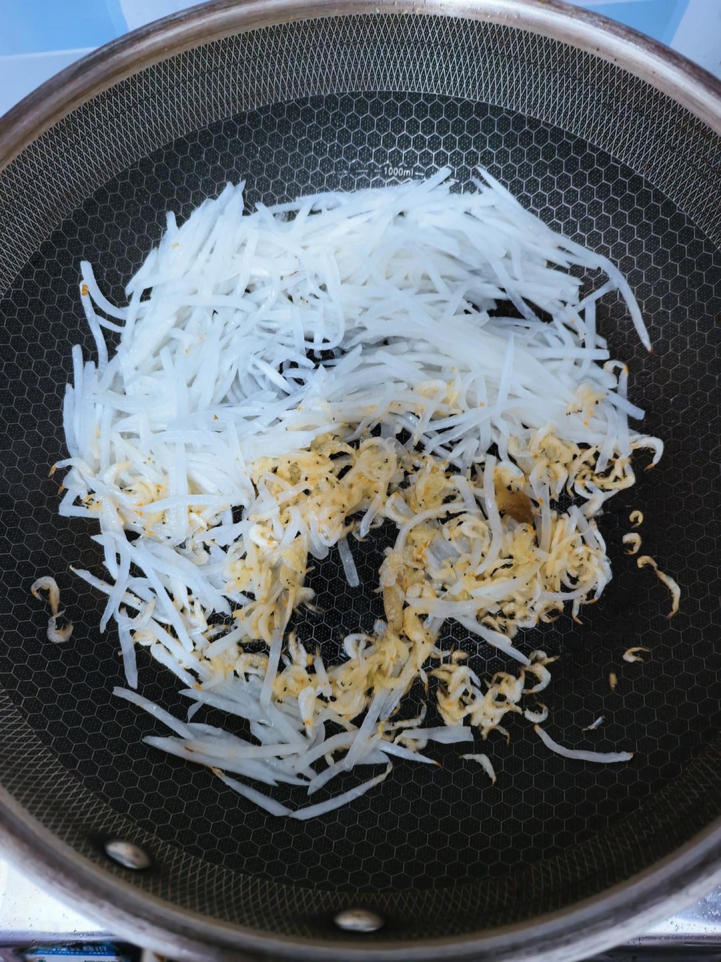 Scatter in the rinsed dried shrimp and stir-fry for another minute so they toast and perfume the radish.