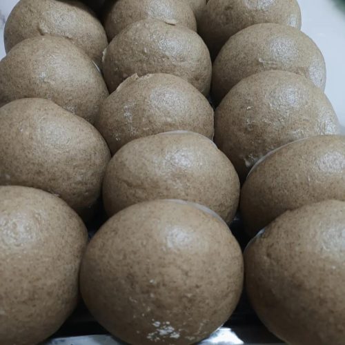 Whole wheat multigrain steamed buns stacked in a bamboo steamer