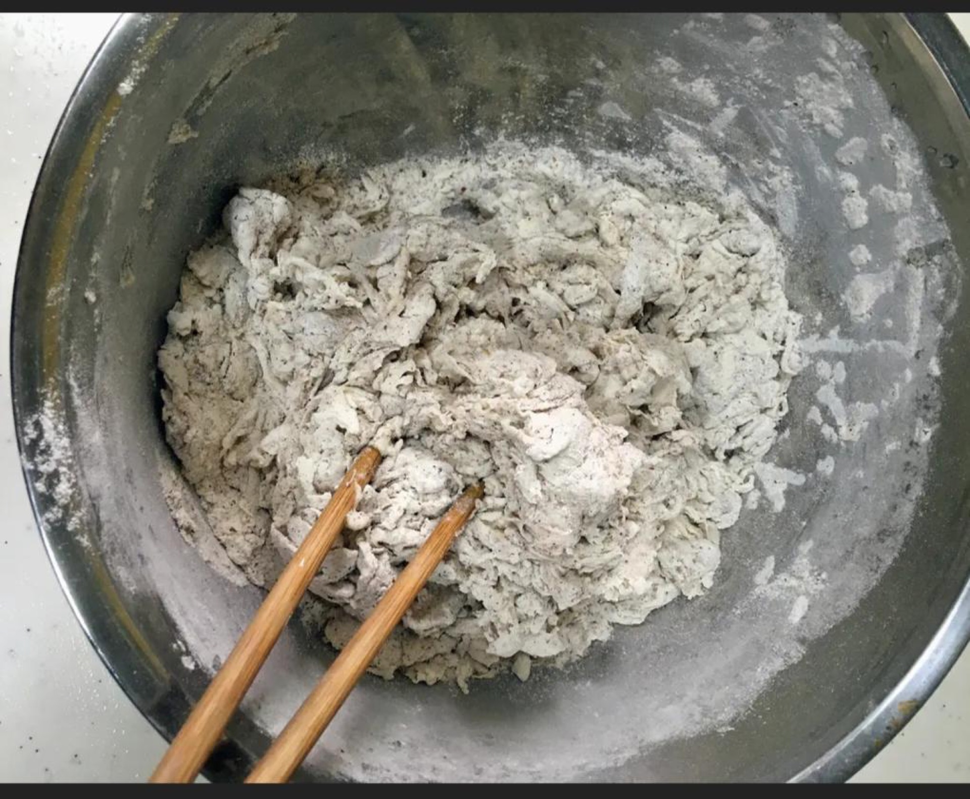Stir the mixture until no dry flour remains, then turn it out and start kneading the shaggy mass into a cohesive ball.