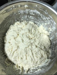 Keep kneading until the dough is smooth and elastic, then cover it and let it rest so the gluten relaxes and the dough rises.