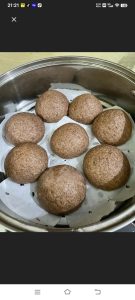 Divide and roll the risen dough into smooth round buns, set them on parchment in the steamer, and let them proof a second time until they feel light and spring back slowly.