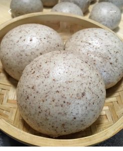 Turn off the heat, rest the covered steamer 3-5 minutes, then lift the lid and serve the buns warm as a sugar-free whole grain meal.