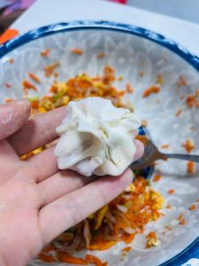 Pinching four corners of a wonton wrapper together