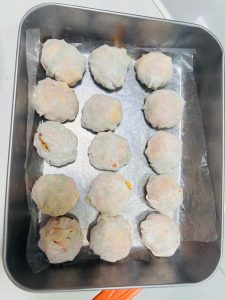 Two boxes of wrapped wonton dumplings ready to steam