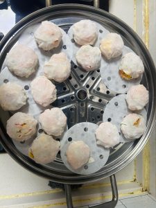Steamed dumplings in a bamboo steamer basket