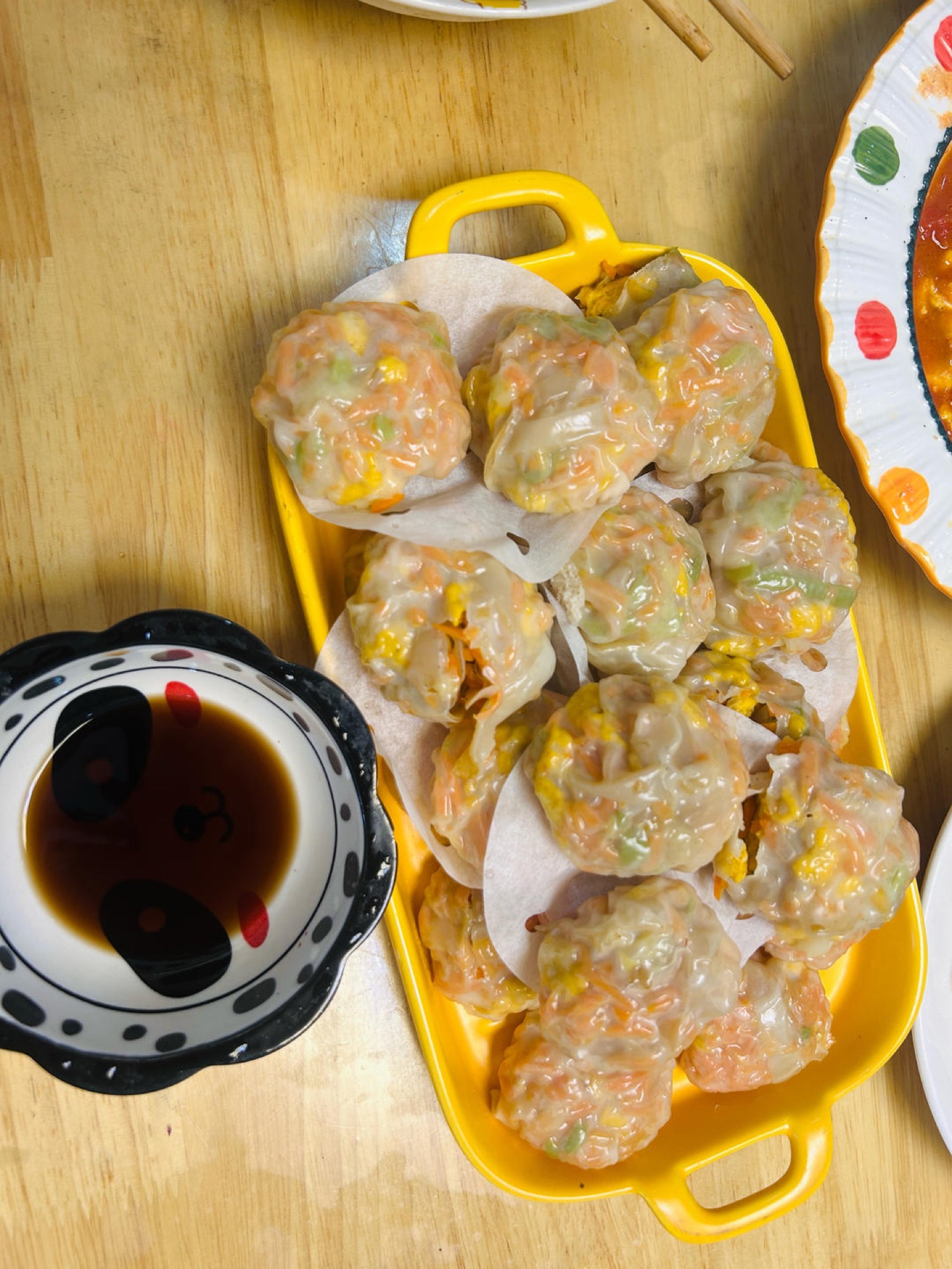 Steamed dumplings served with chili oil and black vinegar dipping sauce