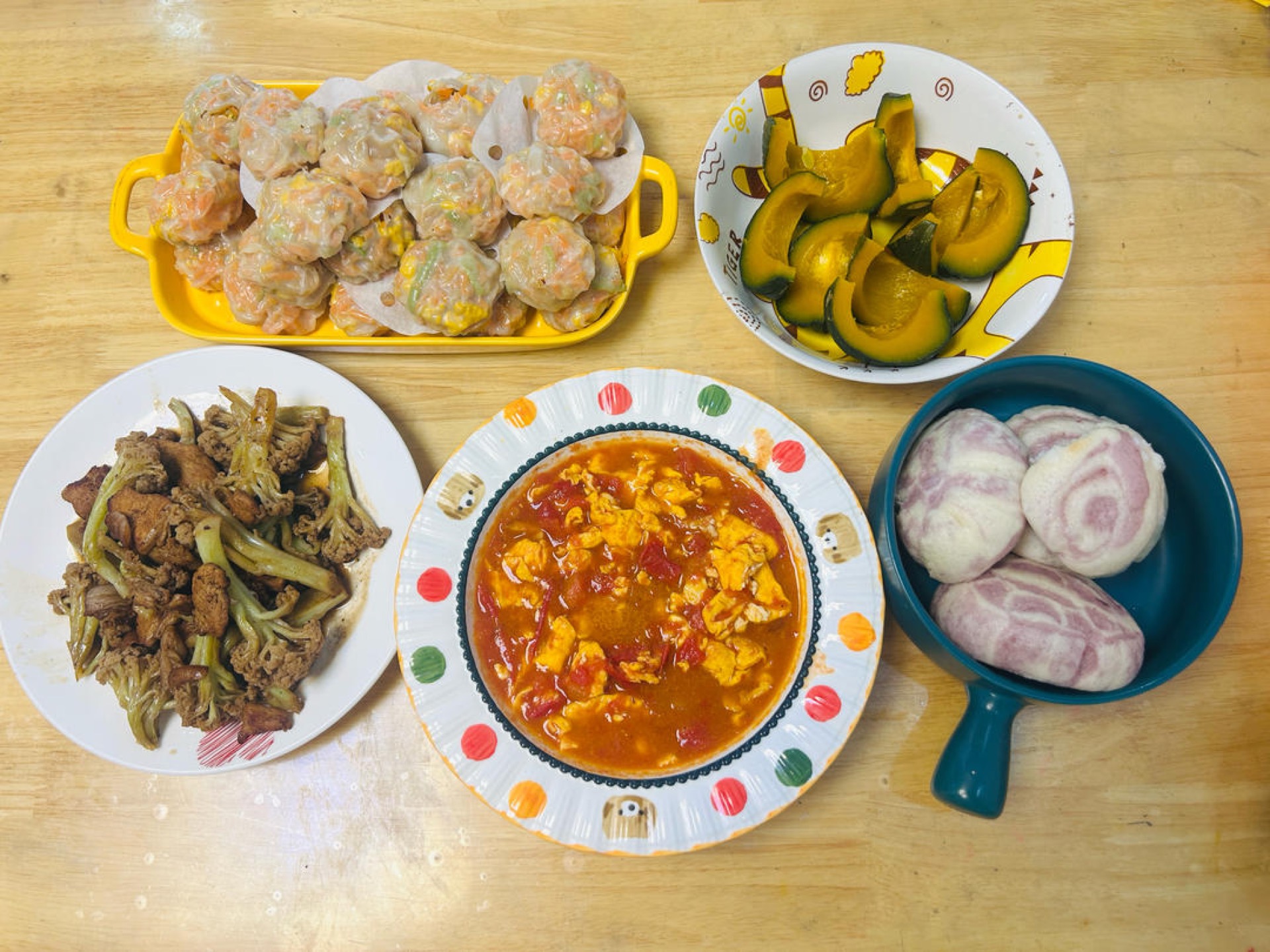 Steamed pumpkin and purple sweet potato buns alongside the dumplings
