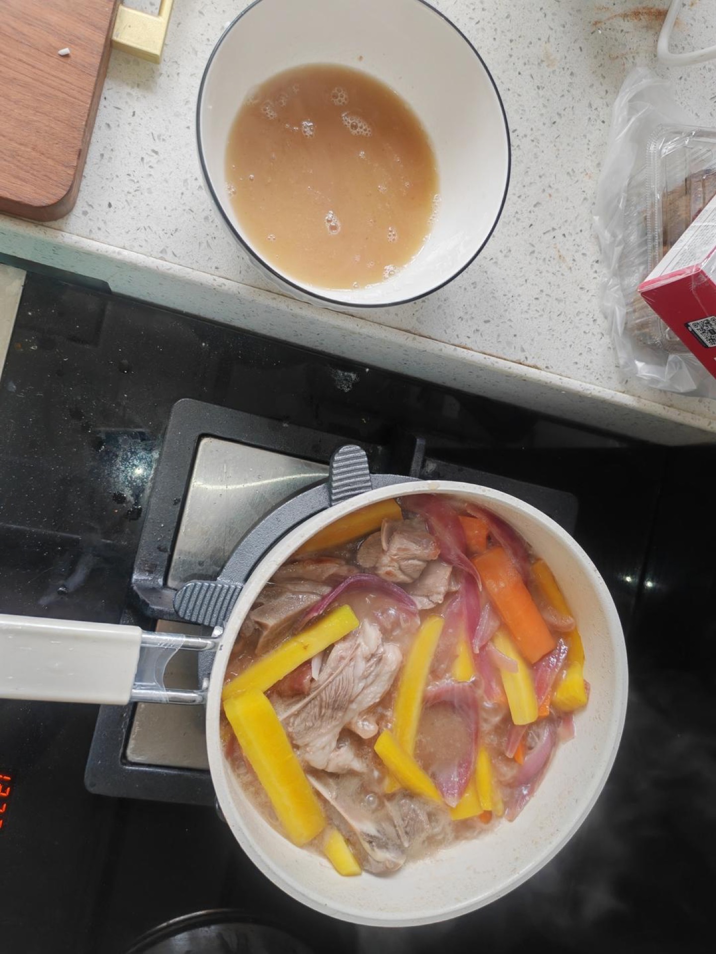 Pour hot water into the wok until it just covers the lamb, stir well, then scoop out about half a bowl of the liquid and add the raisins.