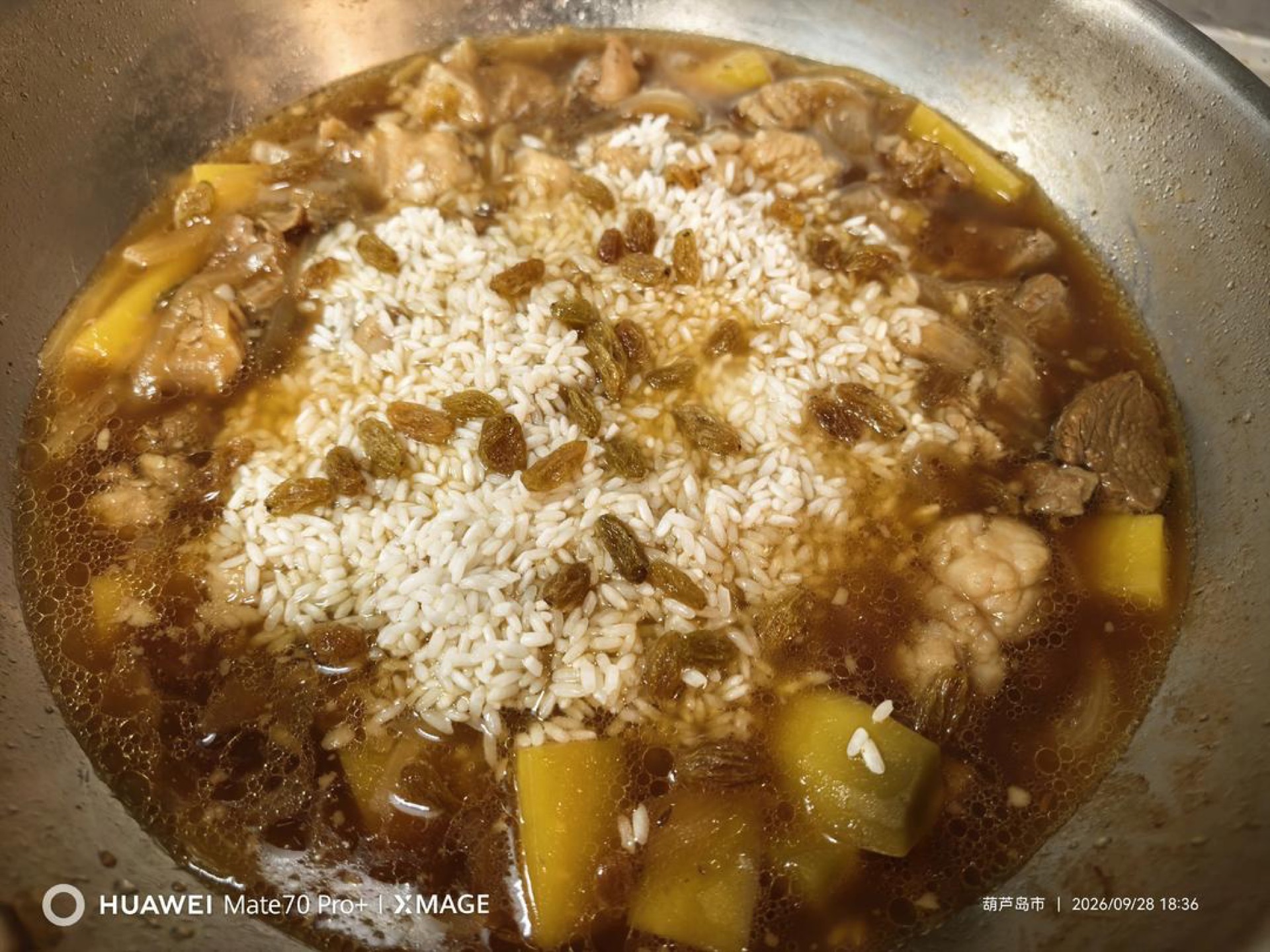 Add the drained rice and raisins.