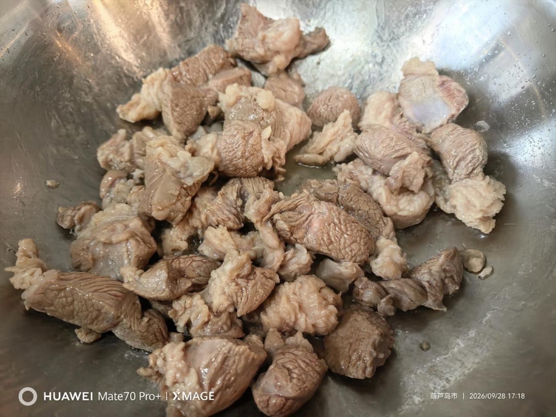 Sear the lamb in the wok until the meat tightens and browns.