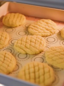 Yogurt cookies baking on a parchment-lined tray