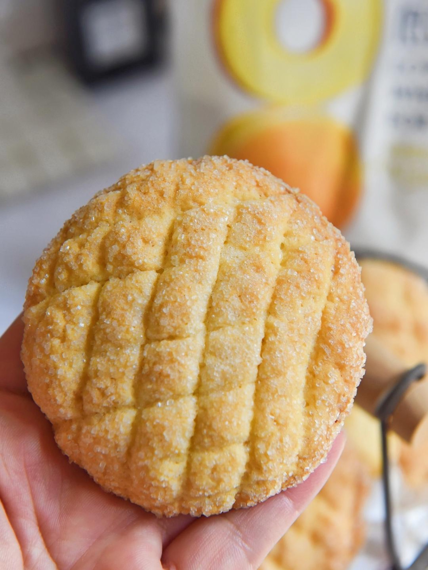 A yogurt cookie broken in half showing crisp texture