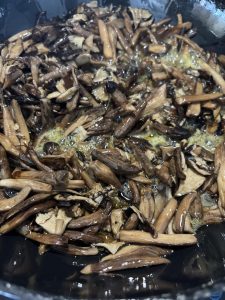 Mushrooms being stirred constantly over low heat