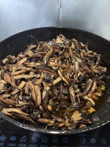 Second batch of mushrooms being fried