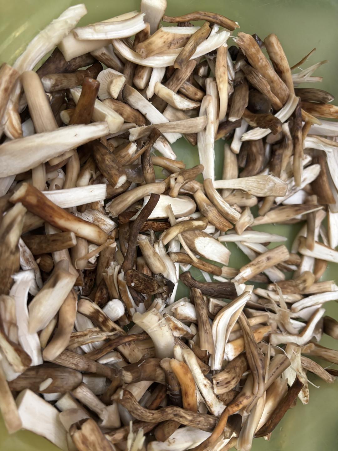 Mushroom stems being cut into even segments