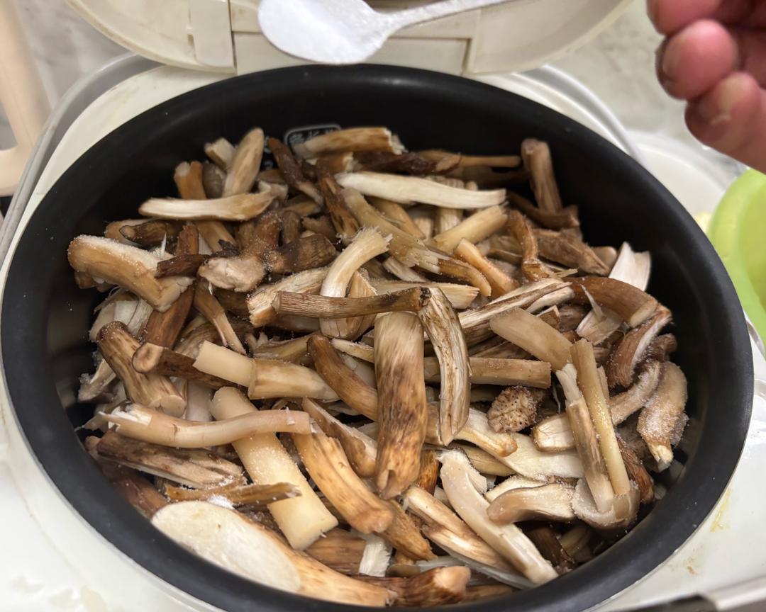 Mushrooms pre-cooking in the rice cooker with salt