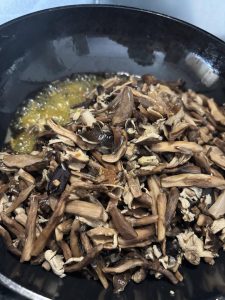 Pre-cooked mushrooms frying in rapeseed oil
