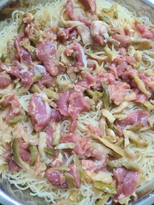 Scatter the pork slices and pickled mustard in an even layer over the noodles, then once the water is boiling set the plate into the steamer and steam over high heat for about 10 m