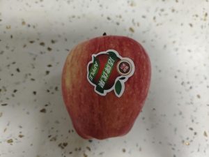 Take one apple and set it on the cutting board.