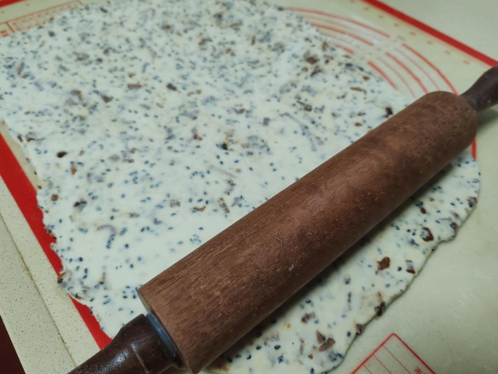 Dust the surface with flour and roll the dough out into a large rectangle.