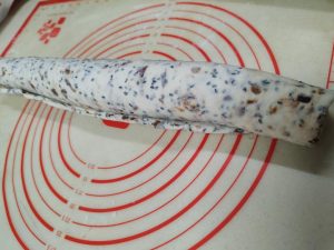 Spritz the surface lightly with water, then roll the dough up into a tight log.