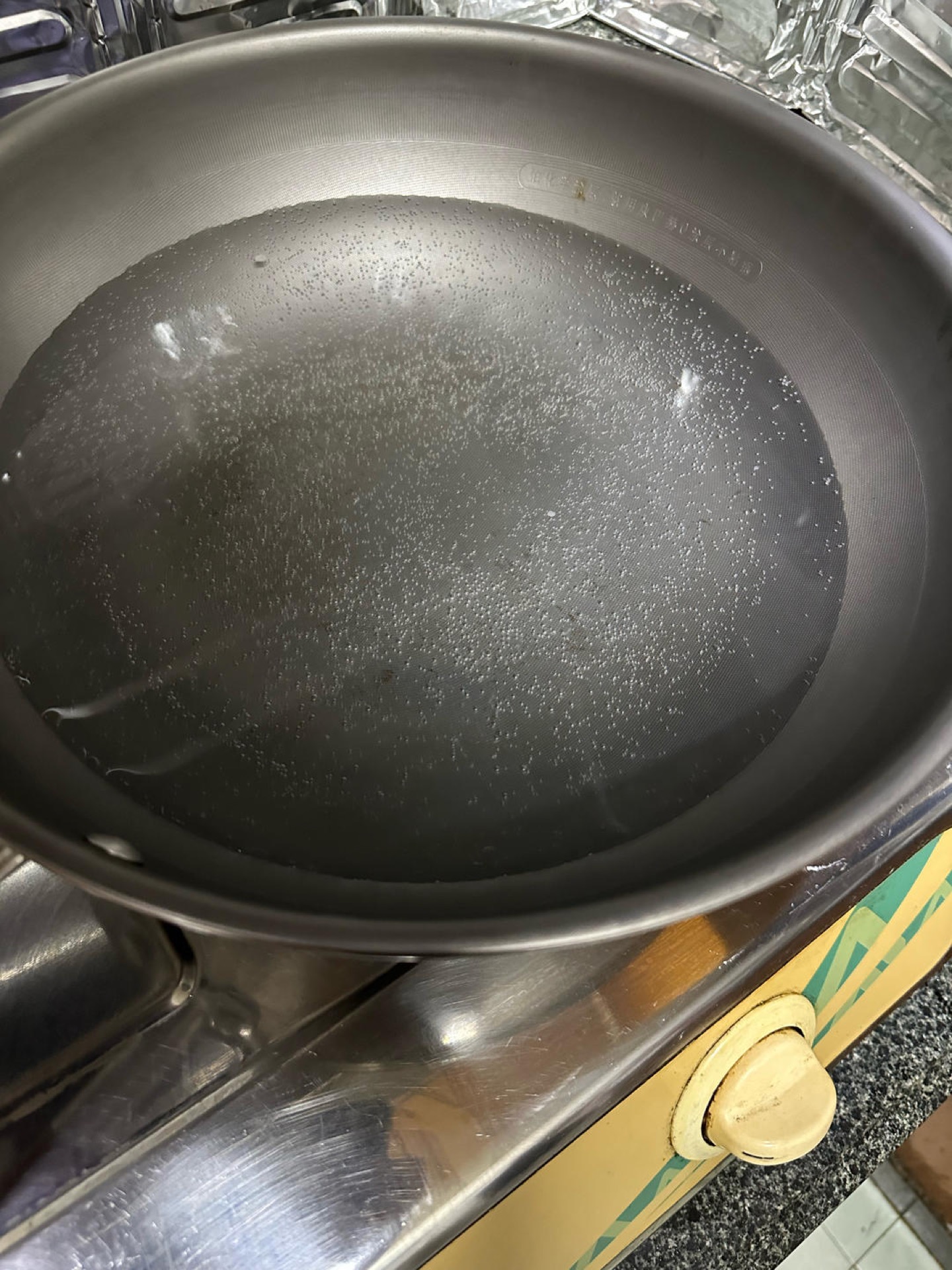Bring a large pot with plenty of water to about 70–80°C (158–176°F) — the bottom of the pot should be covered with a dense cluster of tiny bubbles and the water should be making a