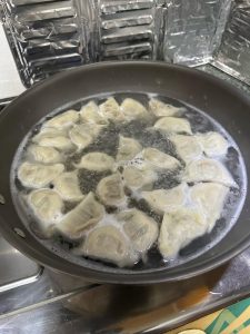 As soon as they're cooked, lift the dumplings out with a slotted spoon and let them drain briefly before plating — don't leave them sitting in the hot water. There's no need to rin