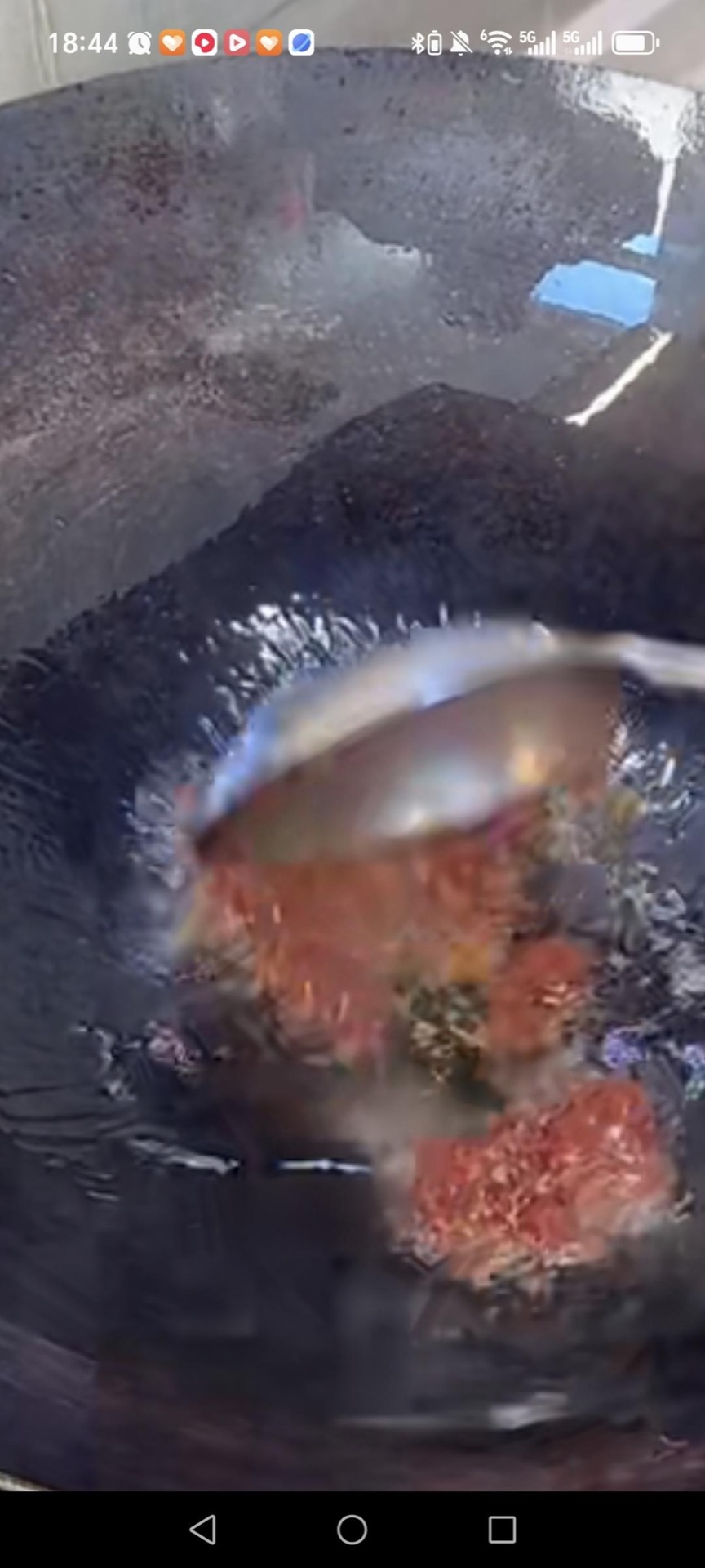 Heat a wok over high heat, add oil, and add the doubanjiang (finely minced with a knife first), frying until the red oil releases.