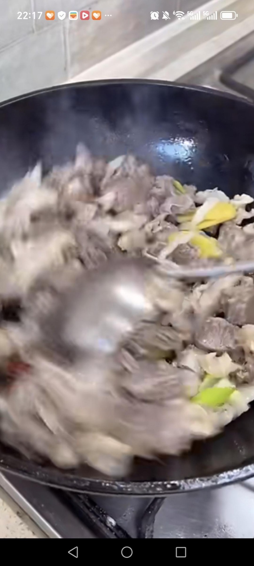 Add the blanched beef to the wok and stir-fry until the pieces release their moisture and begin to brown at the edges.