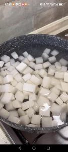 Bring a separate pot of water to a boil, add a pinch of salt, blanch the daikon chunks for 1 minute, then drain well.