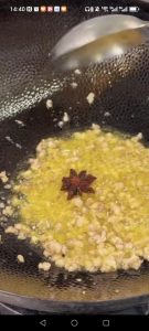 Add the ground pork and stir-fry until cooked through, then add one star anise.