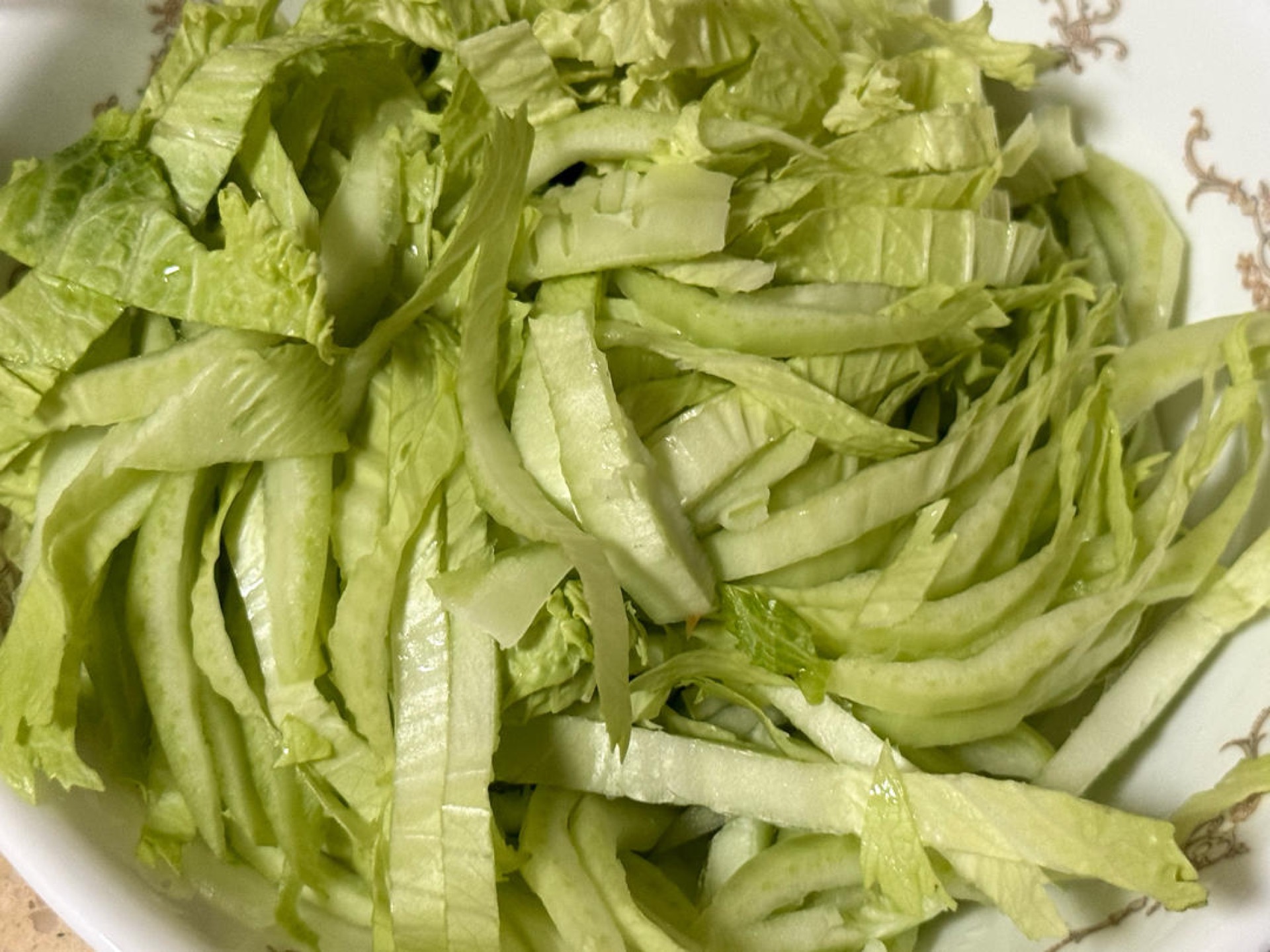 Wash the napa cabbage well, drain it, and cut it crosswise into strips about 1 inch wide, keeping the tender leaves and the thicker white ribs separate.