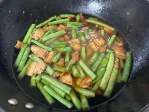 Pour in enough water to just cover the ingredients, bring it to a boil, then ladle out about half a bowl of the broth and set it aside for later.