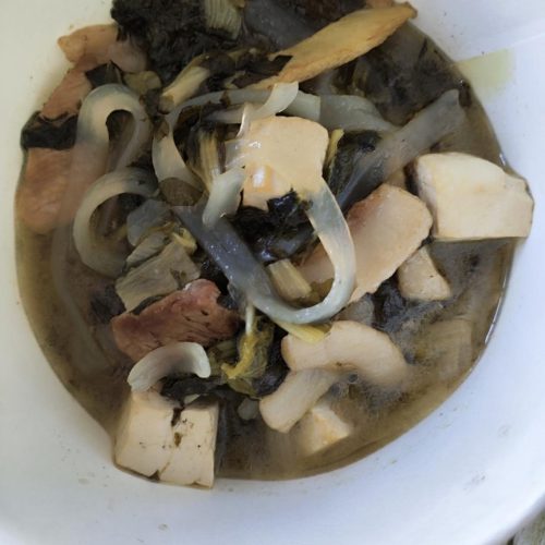 Braised pork with baby bok choy, tofu and glass noodles in a wok