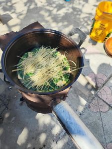 Rinse the glass noodles clean and spread them over the top layer and let them simmer for a while.