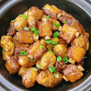 Braised pork ribs with taro served in a clay pot, glossy ribs and golden taro cubes in a rich sauce