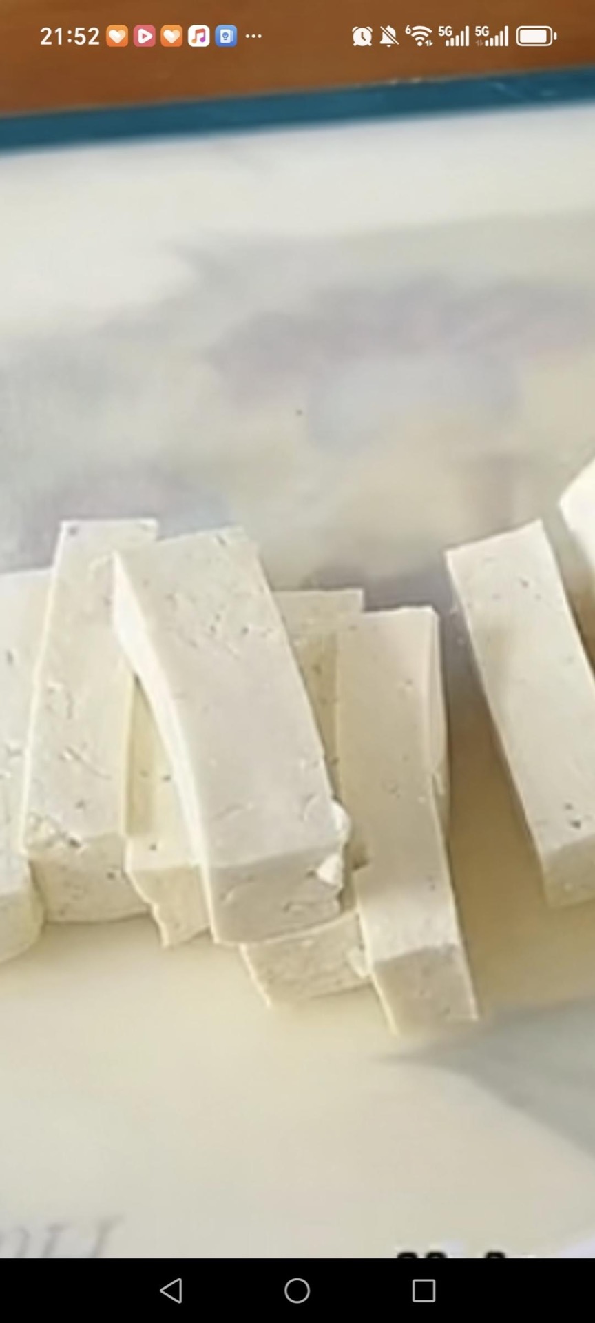 Cut the drained block of firm tofu into thick strips, roughly 3 inches long and 1/2 inch wide, keeping them as even as you can so they brown at the same rate.