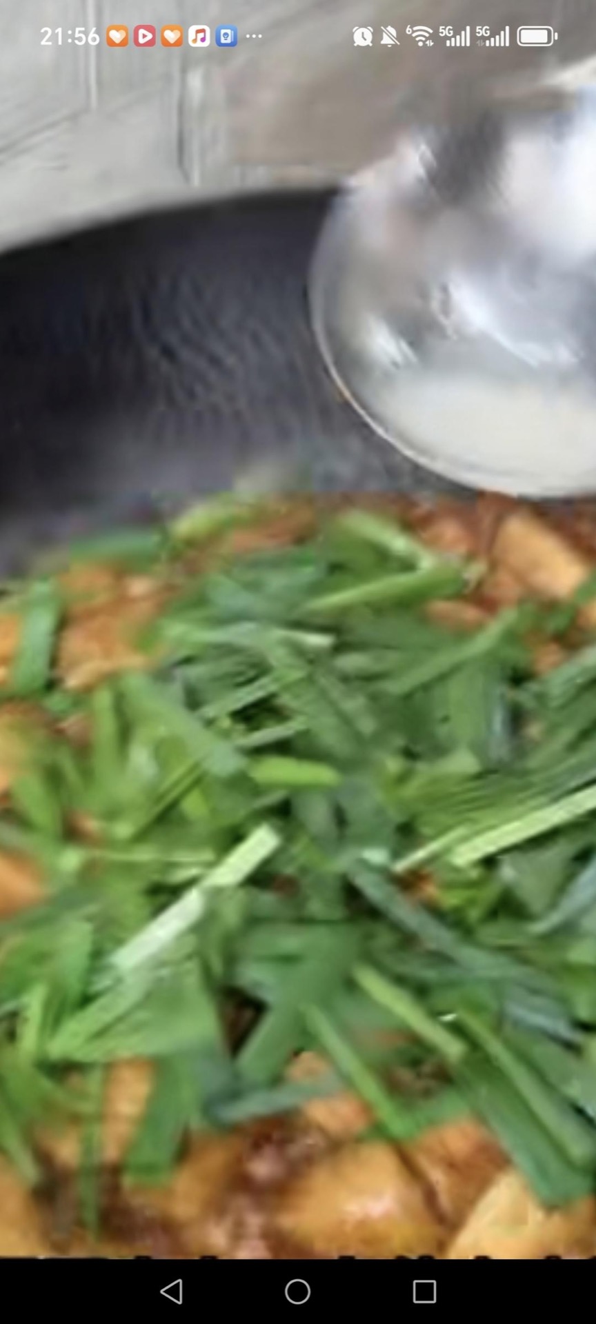 Add the garlic chives and drizzle in the cornstarch slurry, stirring so the sauce thickens around the tofu and the chives just wilt.