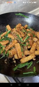 Give everything one last gentle toss, coating the tofu and chives in the glossy sauce, and get ready to plate.