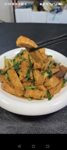 Slide the braised tofu with chives onto a serving plate and serve hot with steamed rice.