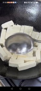 Slide the tofu strips into the wok in a single layer and pan-fry them, undisturbed, for 2 to 3 minutes per side until the edges turn golden and crisp.