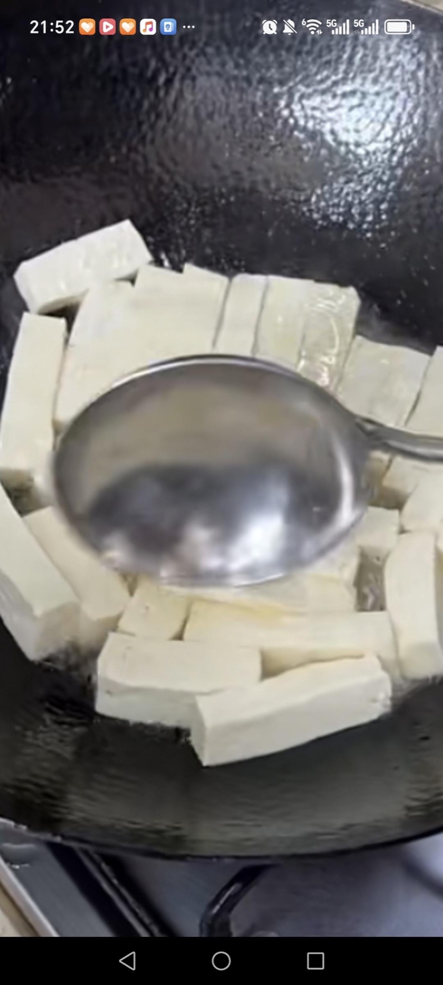 Slide the tofu strips into the wok in a single layer and pan-fry them, undisturbed, for 2 to 3 minutes per side until the edges turn golden and crisp.